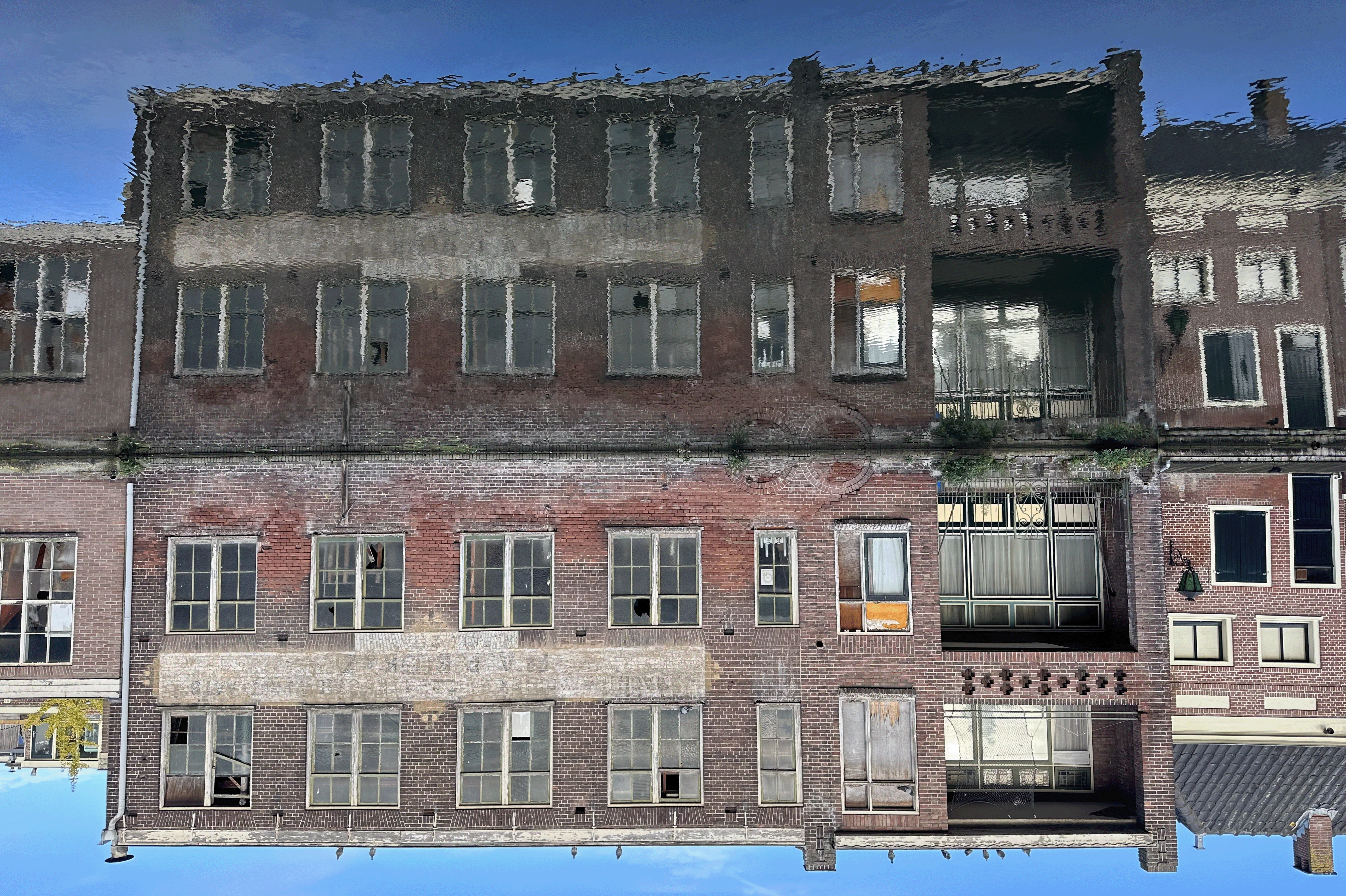A drawing of a building reflected in a canal. The picture is drawn upside down, so the reflection is on top, creating a disorienting effect.